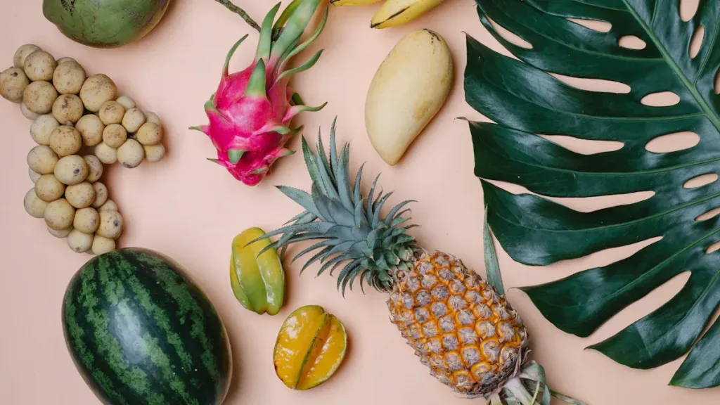 Assorted tropical fruits on a pastel background representing vibrant fruit flavors.
